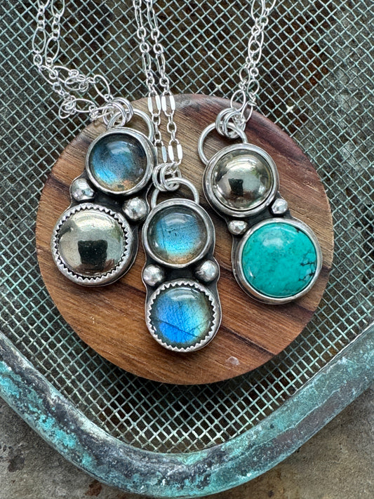 Double gemstone necklaces with sterling silver chain on a display